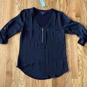 Black half zip blouse.